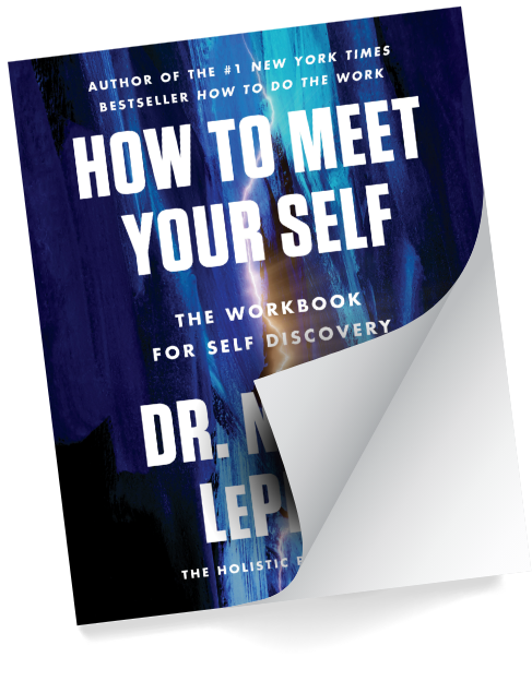 The How to Meet Your Self workbook, its cover curling open at one corner